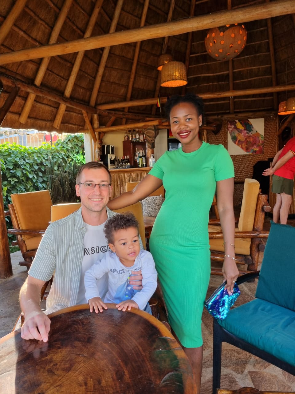 Family photo at a restaurant with a child at the table.